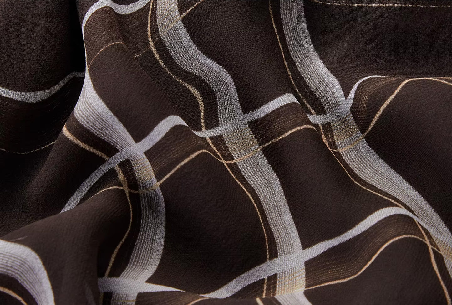 Texture detail of the Café Mirage silk georgette showing the almost opaque woven ribbon edges of the rhombus print — From Borcelleclothes.
