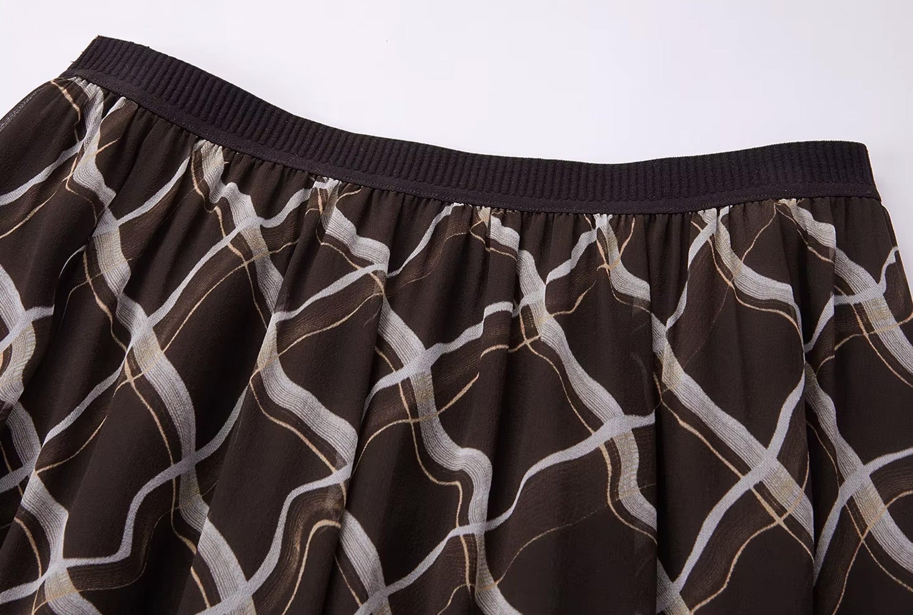 Detailed shot of the comfortable elasticated knit-rib waistband on the Café Mirage silk skirt — From Borcelleclothes.