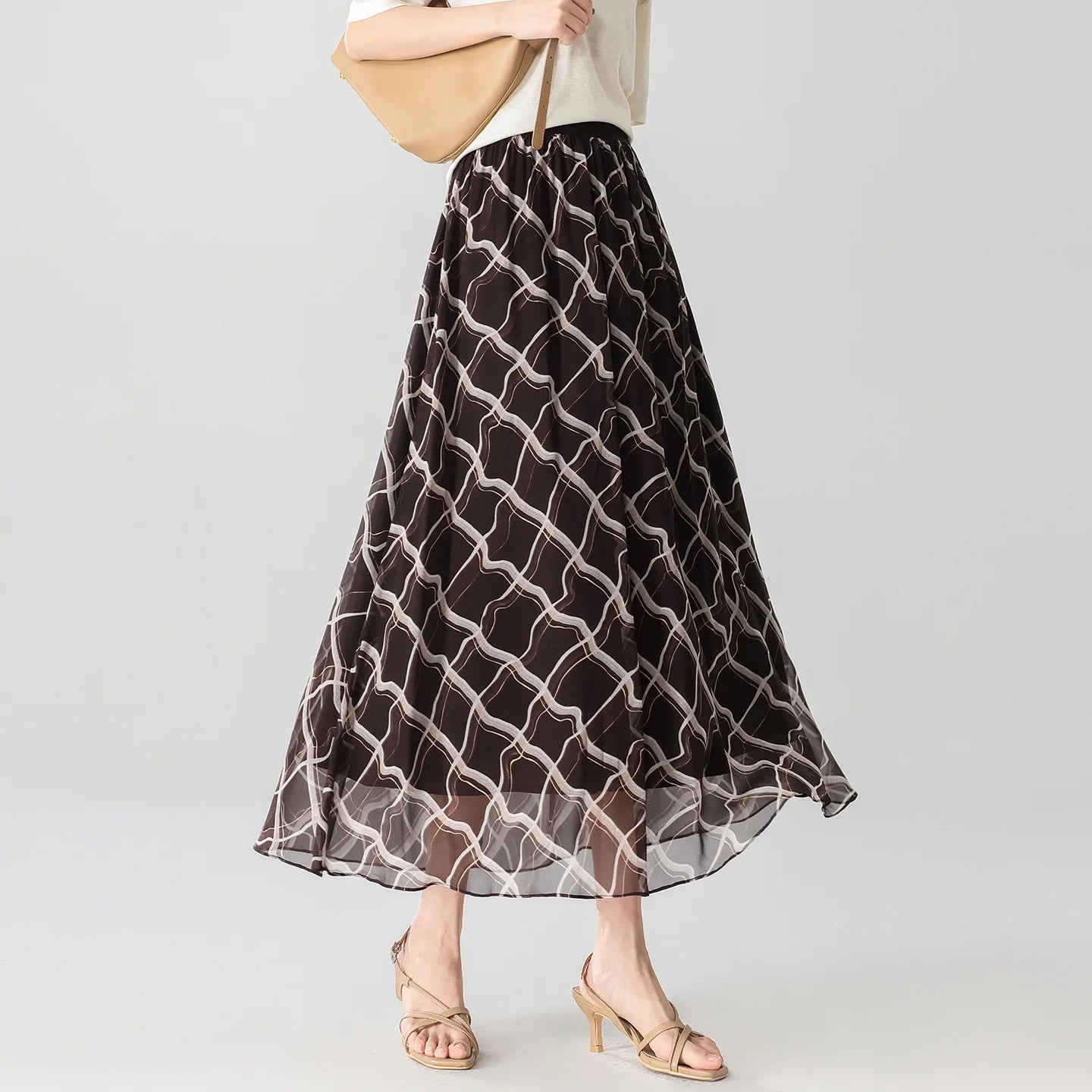 Women's  6A Grade Mulberry silk midi skirt in Café Mirage, featuring an immersive 3D geometric print and a comfortable knit-rib waistband. — From Borcelleclothes.