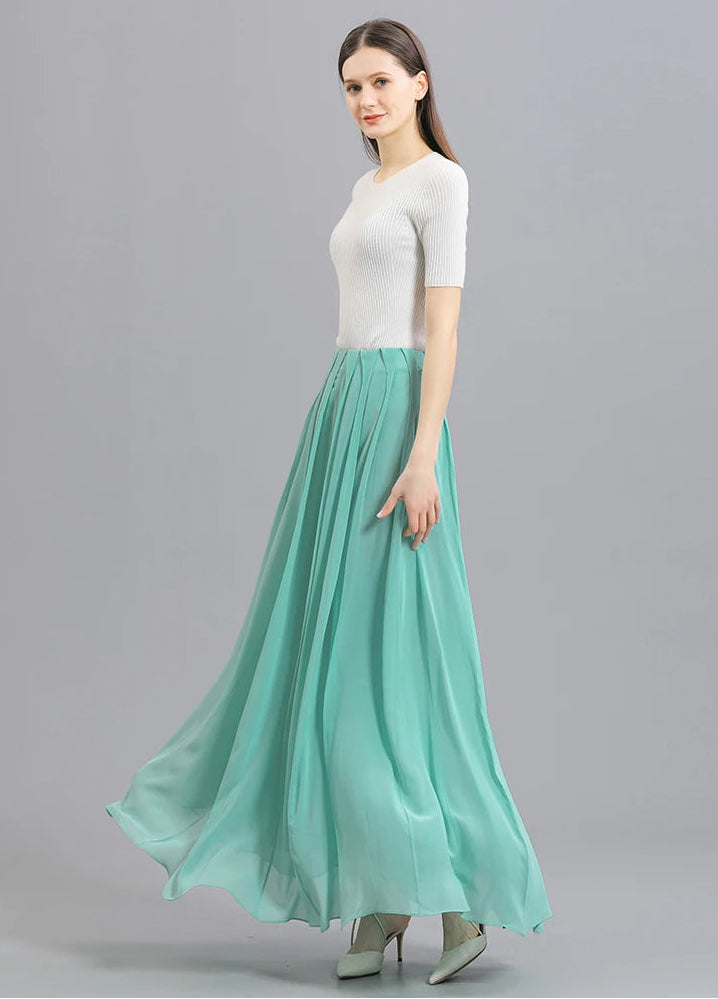 Full-height view of a model swirling to the right in a women's Mulberry silk skirt in Cross Waves — From Borcelleclothes.
