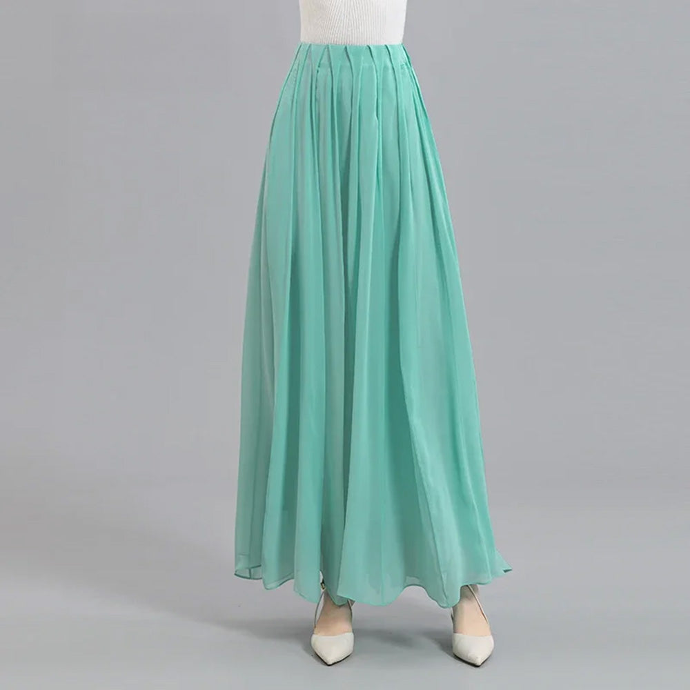 Women's ankle-length 12-momme Mulberry silk georgette skirt in Cross Waves hue. The unique waist pleats open dynamically, forming structural aqua vortexes. — From Borcelleclothes.