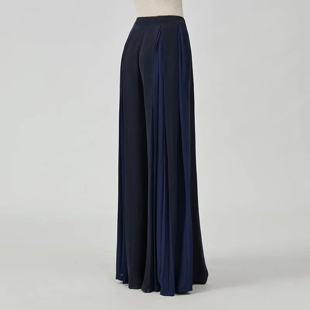 Women's Mulberry silk trousers with georgette inserts in Vortex Flower, featuring a model viewed from the back — From Borcelleclothes.