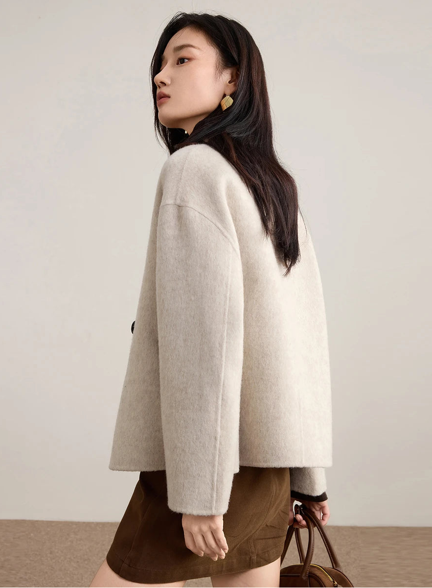 Rear view of a woman wearing the Bohemian wool jacket, showcasing the clean lines and dropped shoulder construction. — From Borcelleclothes.