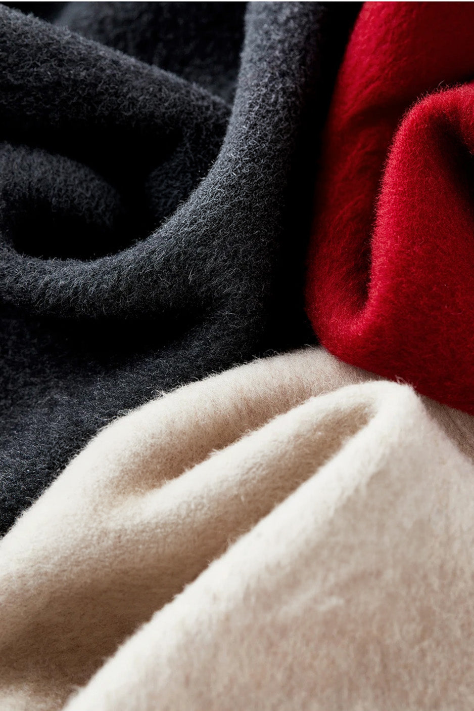 Artistic wave-folded texture of virgin wool fabric in all three colors, highlighting the premium double-faced quality. — From Borcelleclothes.