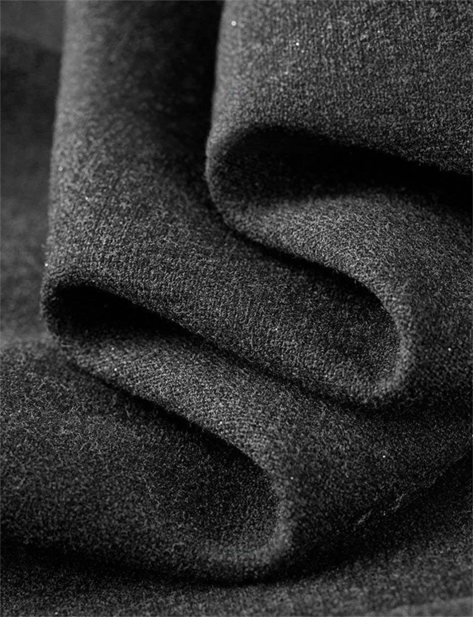 A close-up texture shot of the Improvisation wool blend with silver lurex. The wave-like folds reveal the delicate, metallic shimmer, capturing the spirit of a "ghost note" in jazz. — From Borcelleclothes.