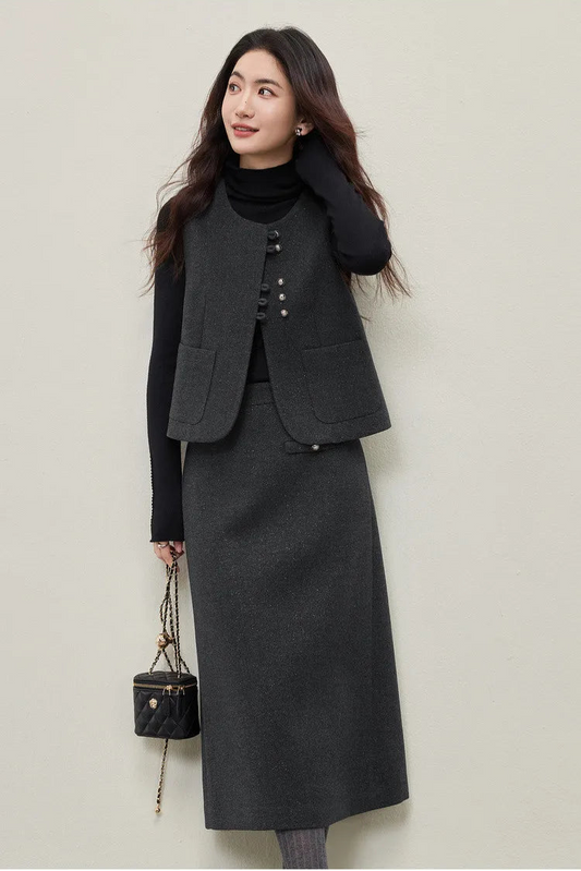 An elegant, minimalist profile of a woman adjusting her hair, wearing the Syncopation black turtleneck and Improvisation silver-lurex vest. She embodies the "quiet tone" and inner rhythm of the collection. — From Borcelleclothes.