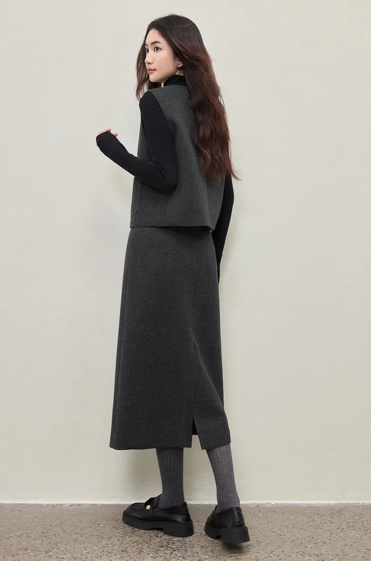 A back view of a woman in the Improvisation midi skirt and Syncopation turtleneck. The central invisible zipper and the clean, tailored darts on the skirt highlight the impeccable fit. — From Borcelleclothes.