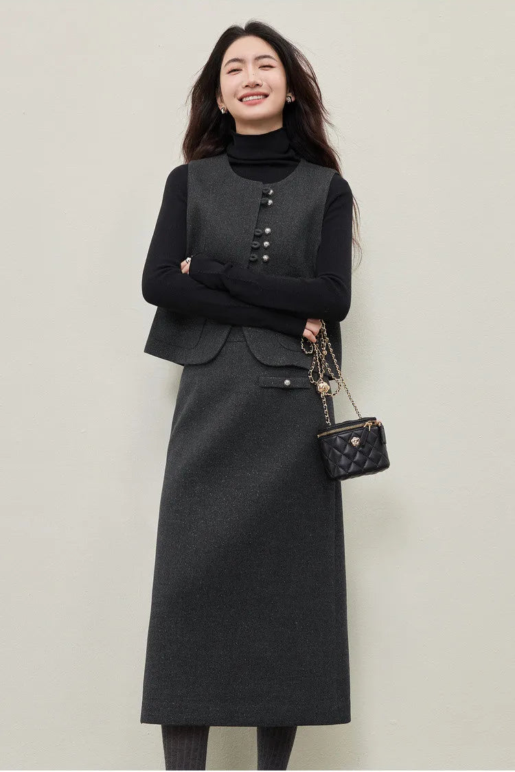 A poised woman standing with arms bent at the waist, emphasizing the slim fit of the turtleneck with its high-stretch ribbed texture and the structured profile of the silver-lurex midi skirt. — From Borcelleclothes.