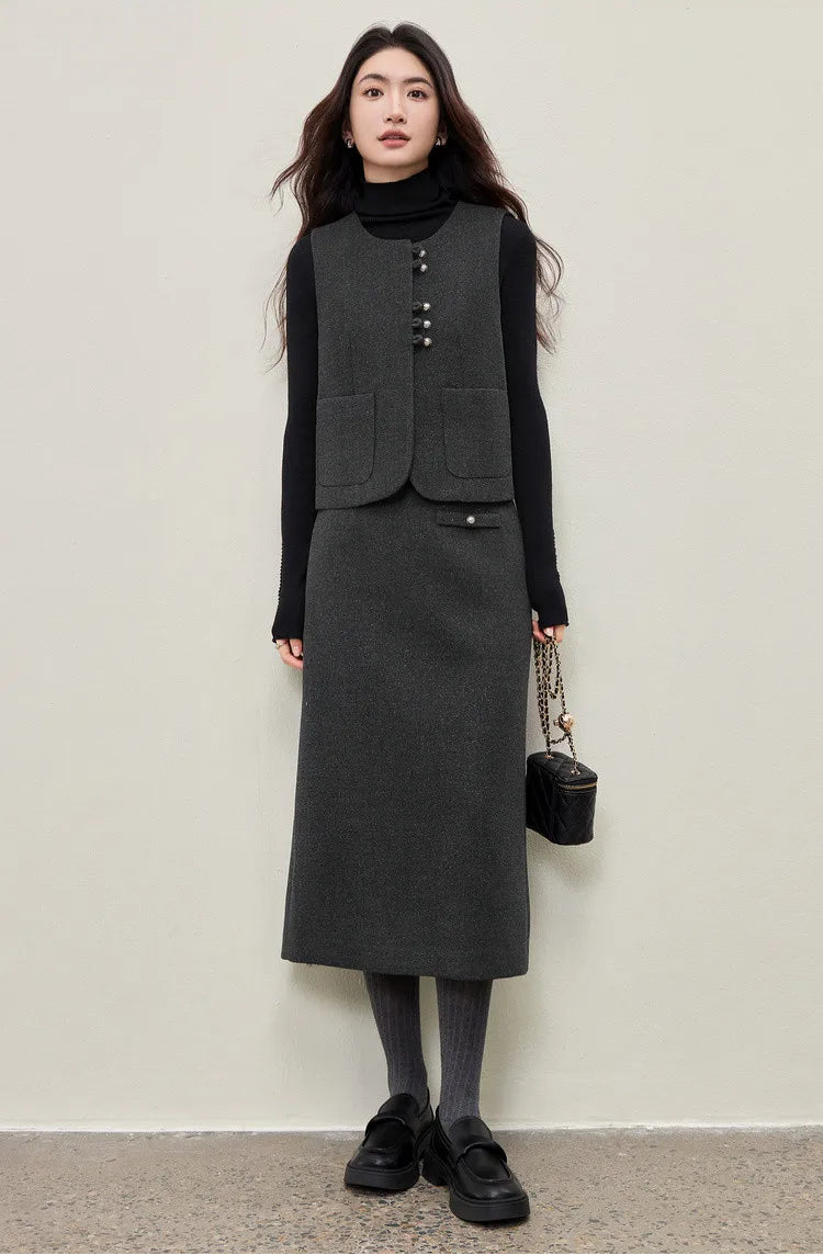 A graceful, full-length shot of a woman in the complete three-piece office ensemble. She stands straight, holding a bag, defining the space around her with structural elegance and a subtle lurex glow. — From Borcelleclothes.
