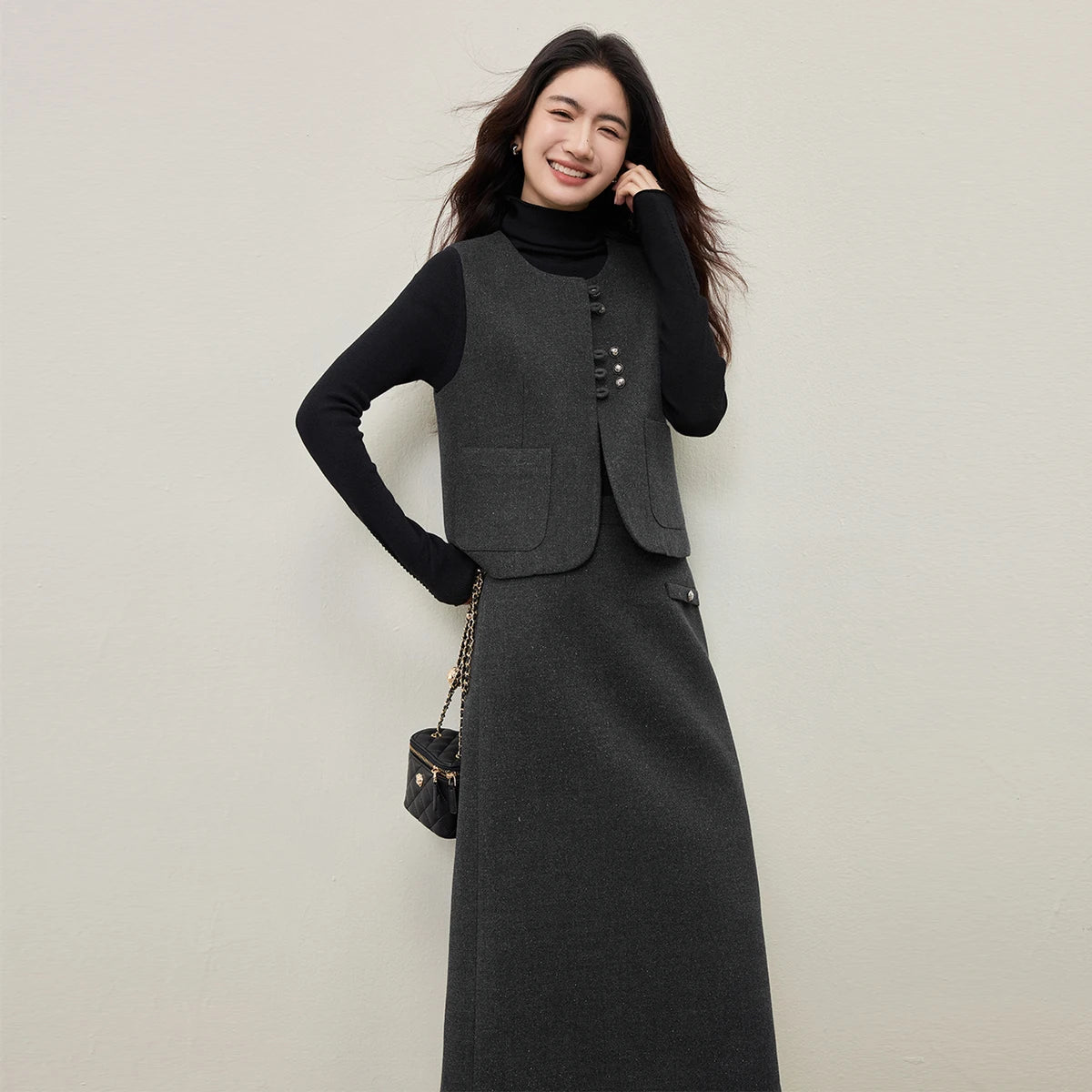 A candid, warm moment of a woman in the silver-lurex set, smiling slightly while adjusting her hair and holding a bag. She brings the "jazz improvisation" to life. — From Borcelleclothes.