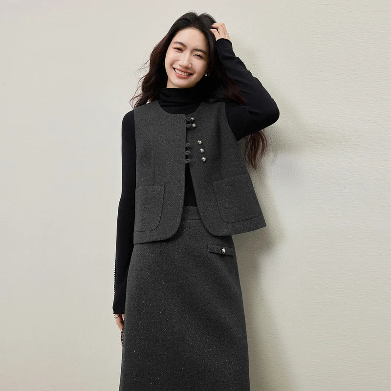 Women's three-piece ensemble in knit (Syncopation color) and silver-lurex wool blend (Improvisation color). Features structural exposed seams, a single-breasted vest with syncopated button grouping, and a midi skirt. — From Borcelleclothes.
