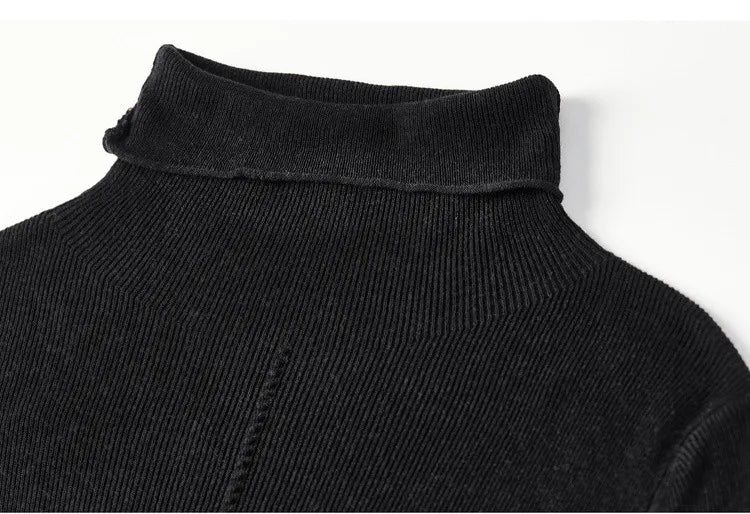 A tactile macro shot of the Syncopation turtleneck, emphasizing the elastic ribbed texture and the bold, vertical decorative exposed seam that defines the front. — From Borcelleclothes.
