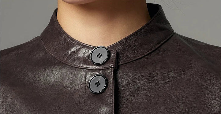 Detail shot of the stand band collar and finished edge stitching on full-grain oil-waxed goatskin leather — From Borcelleclothes.