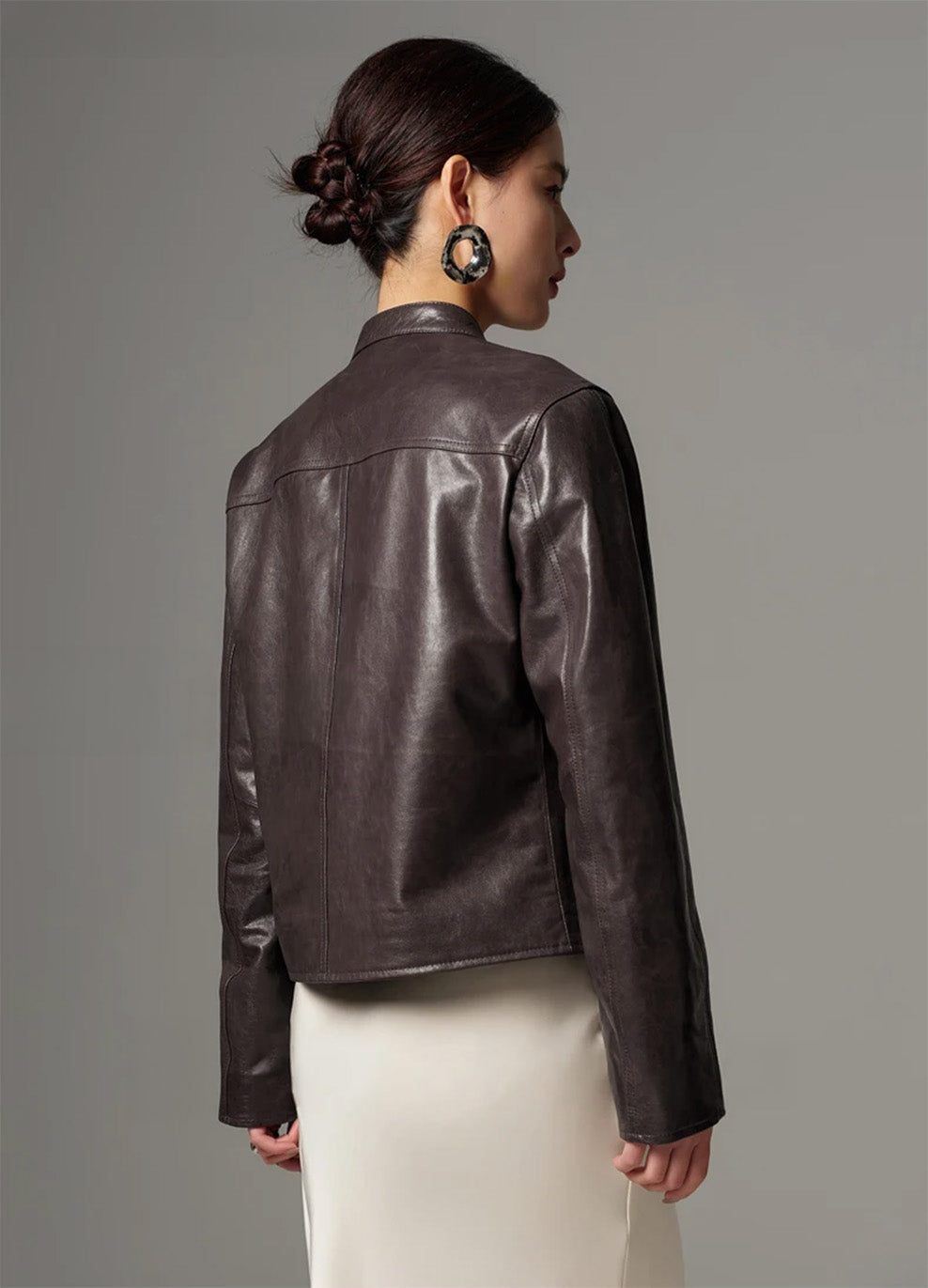 Back view of the women's oil-waxed goatskin jacket displaying the clean horizontal yoke and semi-fitted silhouette — From Borcelleclothes.