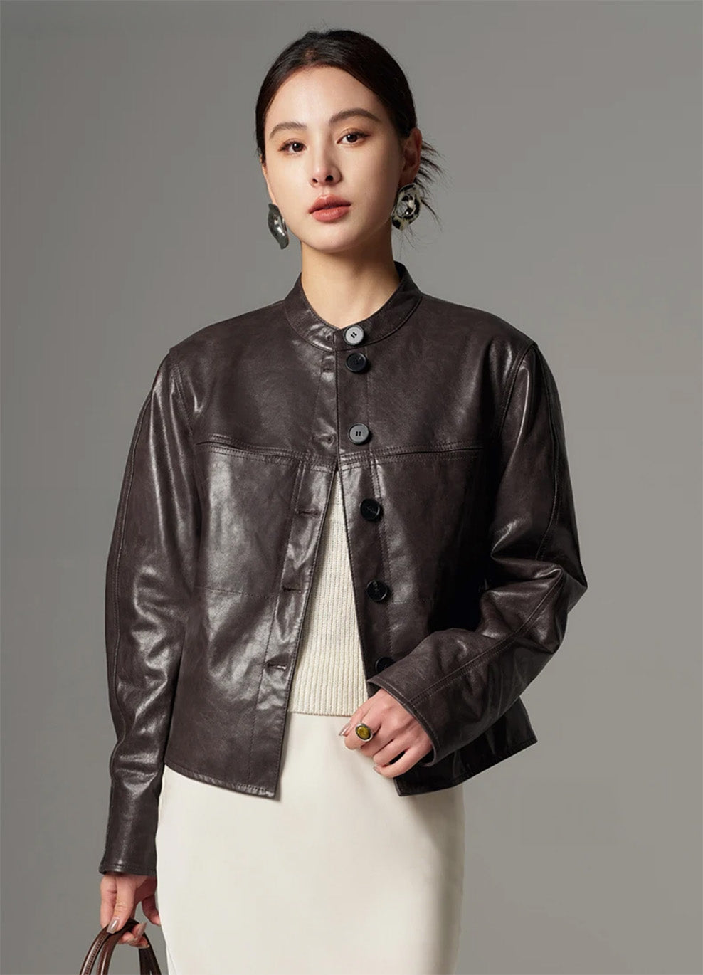 Close view of the goatskin overshirt fastened at the upper button, showcasing the high band collar and tailored front placket — From Borcelleclothes.