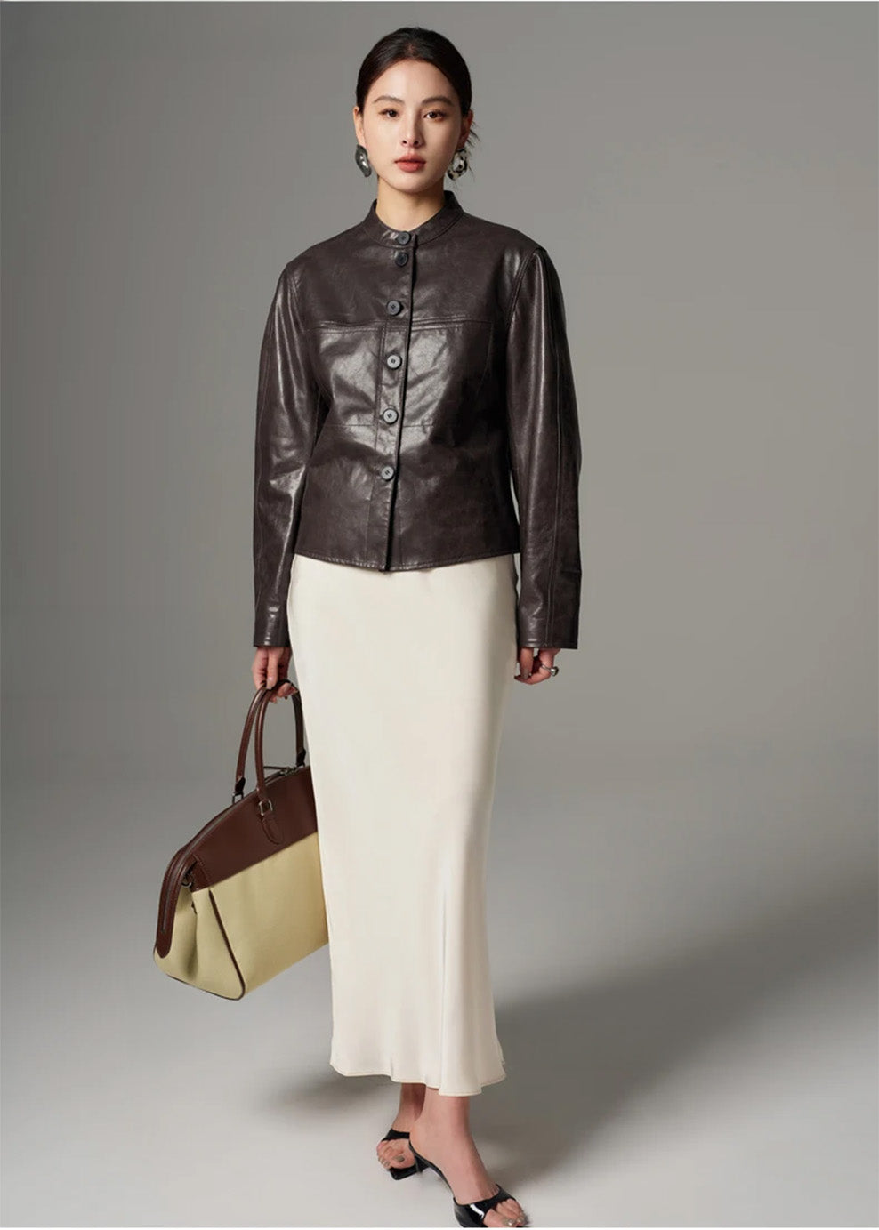 Full-length view of model posing in the semi-fitted oil-waxed goatskin jacket — From Borcelleclothes