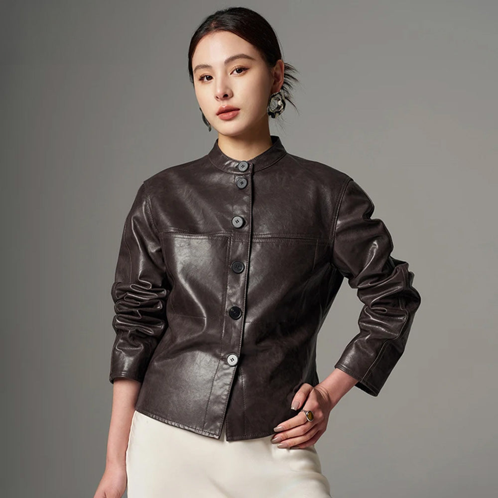 Women's Full-grain oil-waxed goatskin overshirt jacket in First Impression. Architectural band collar, twin-needle detailing, and dynamic espresso pull-up undertones. — From Borcelleclothes.