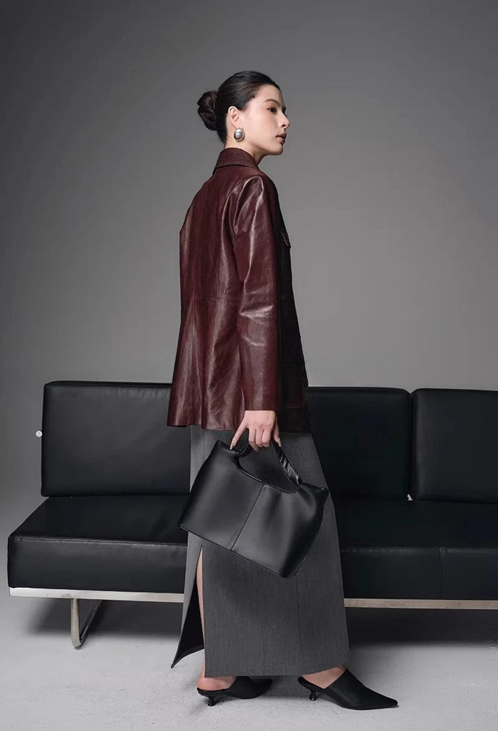 Back view of women's belted oil-waxed sheepskin safari jacket in Vintage Amarone — From Borcelleclothes.