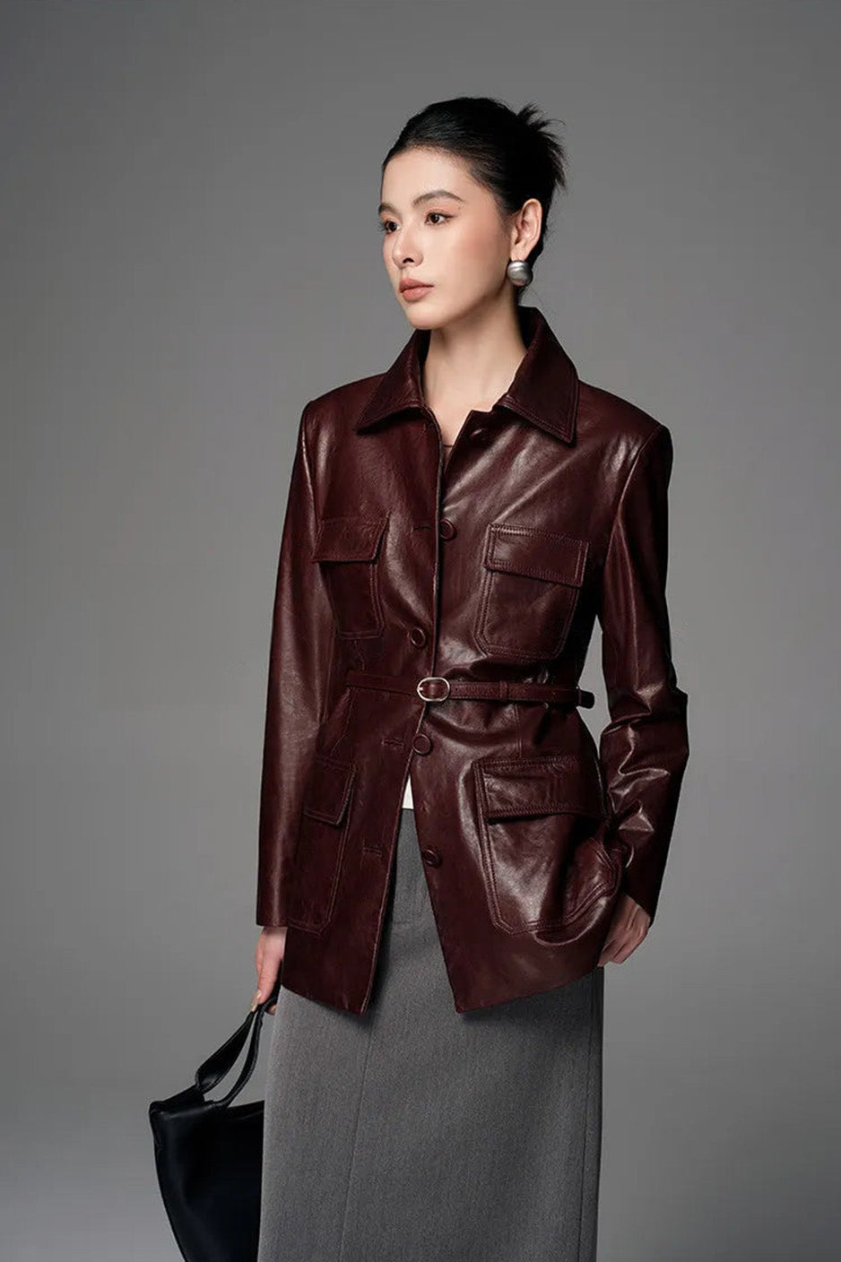 Model holding handbag with head turned in Vintage Amarone waxed sheepskin safari jacket — From Borcelleclothes.