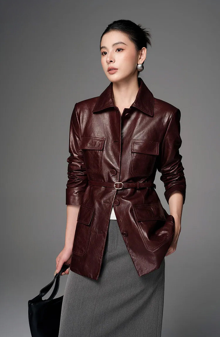 Model gently lifting the hem of the Vintage Amarone waxed sheepskin jacket — From Borcelleclothes.