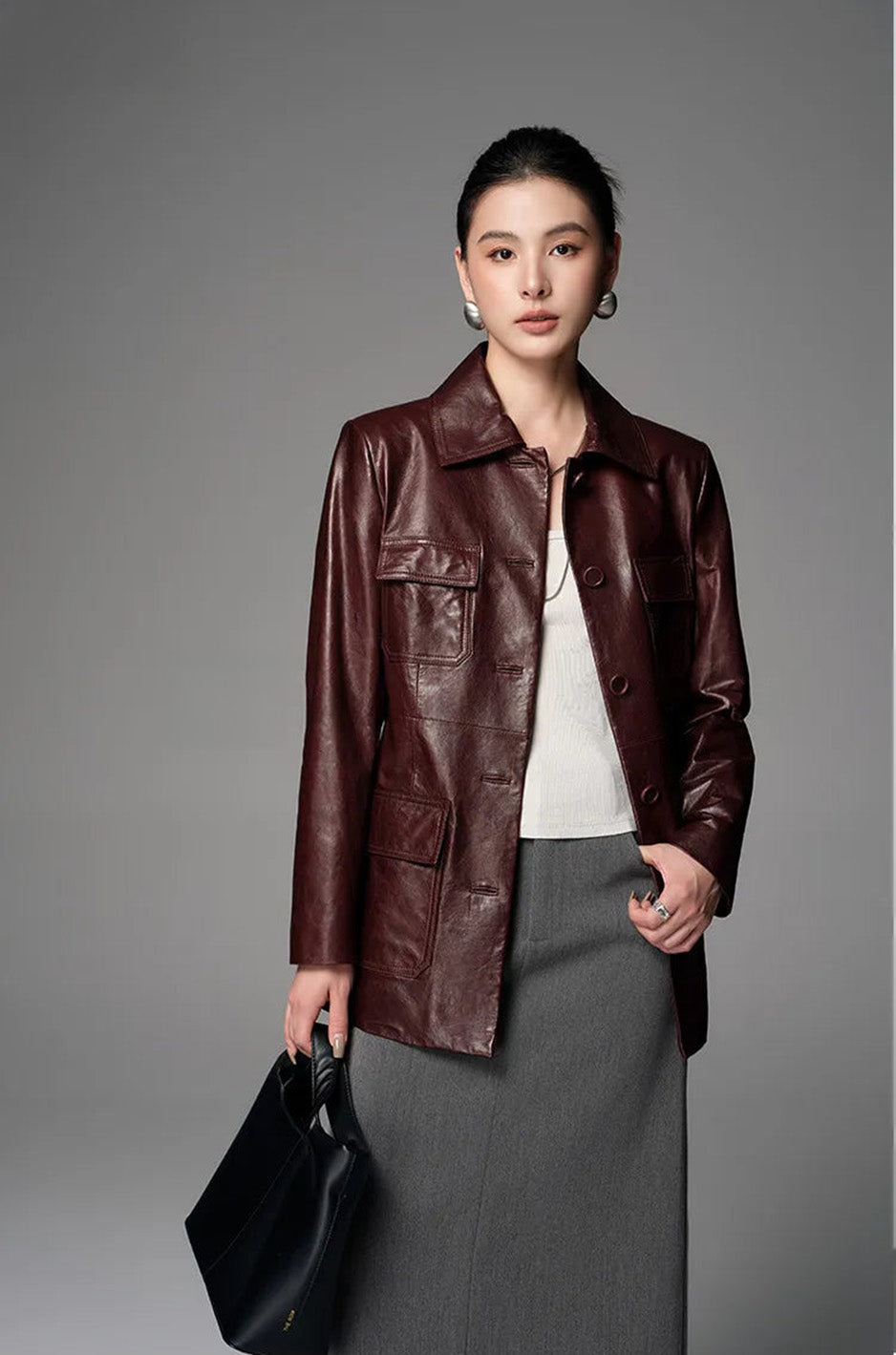 Model posing in Vintage Amarone sheepskin safari jacket with thumb in skirt pocket — From Borcelleclothes.