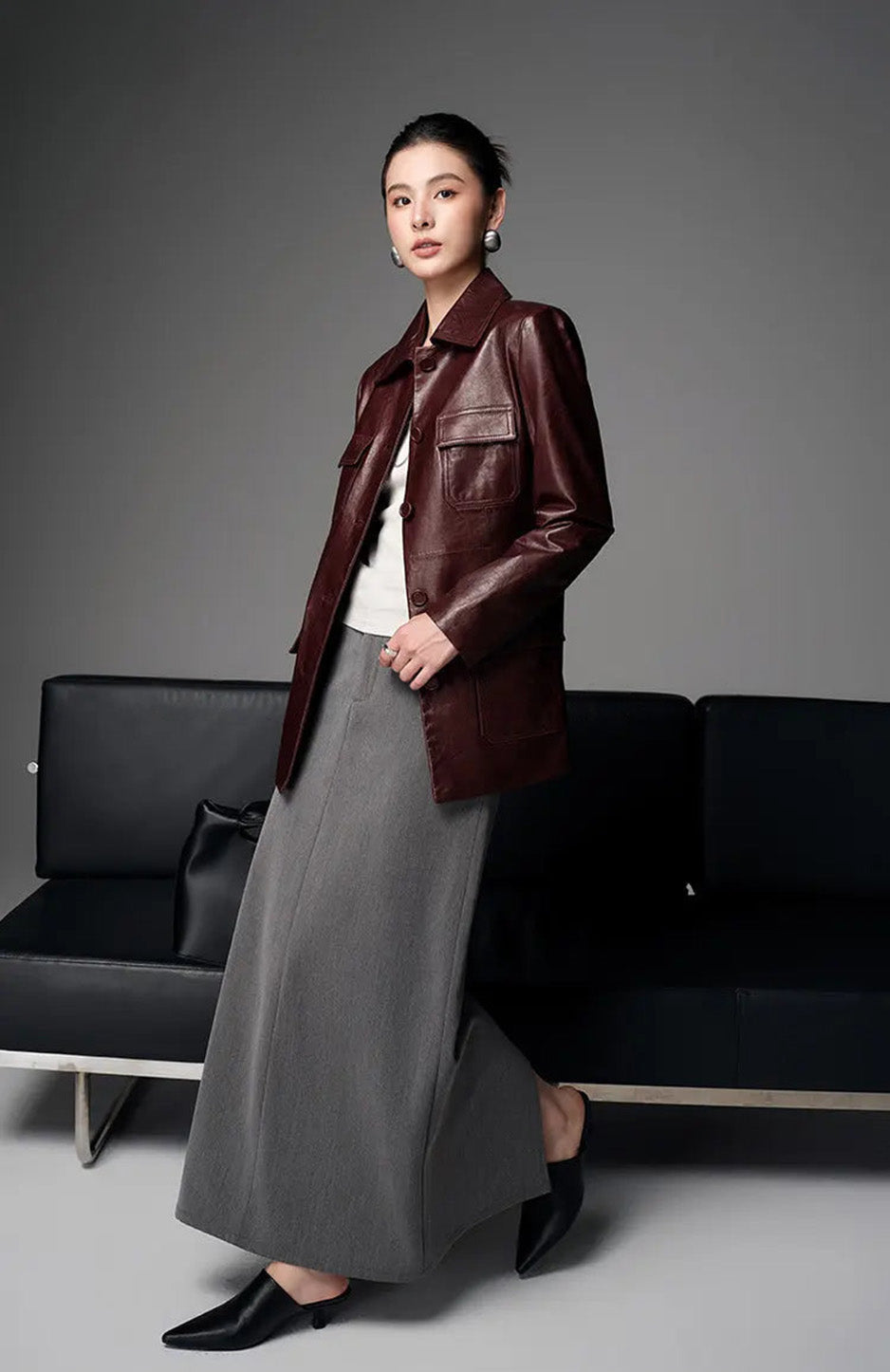 Side profile of model walking in belted Vintage Amarone waxed sheepskin safari jacket — From Borcelleclothes.