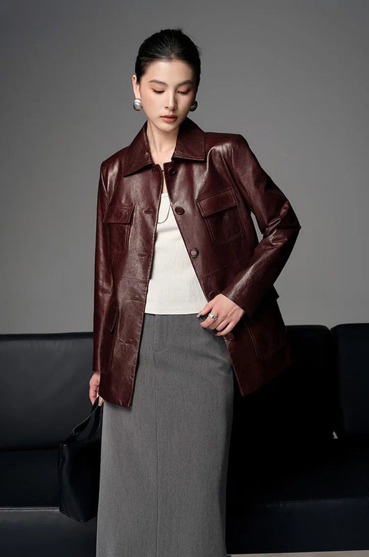 Unfastened oil-waxed sheepskin safari jacket in Vintage Amarone on model with bent arm — From Borcelleclothes.