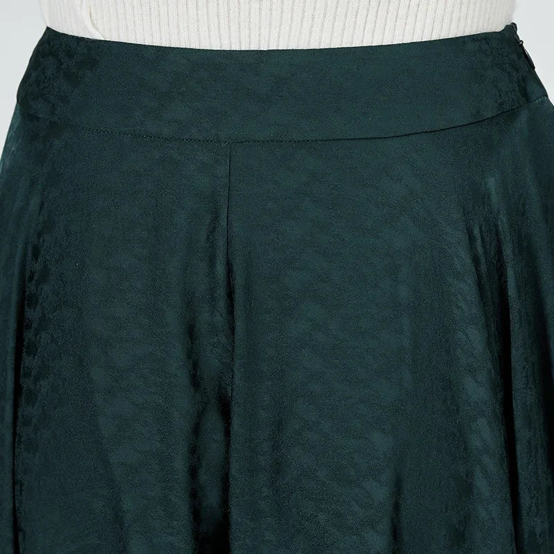 Rear detailed view of the upper section: A woman shows the perfect fit of the silk palazzo trousers. — From Borcelleclothes.