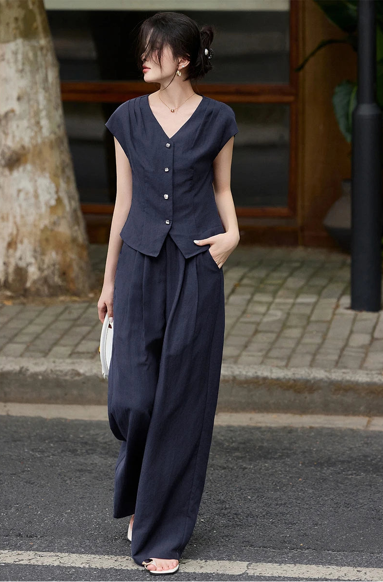 A confident stride in L'Oiseau Bleu; the pleated shoulders create a powerful yet feminine frame — From Borcelleclothes.