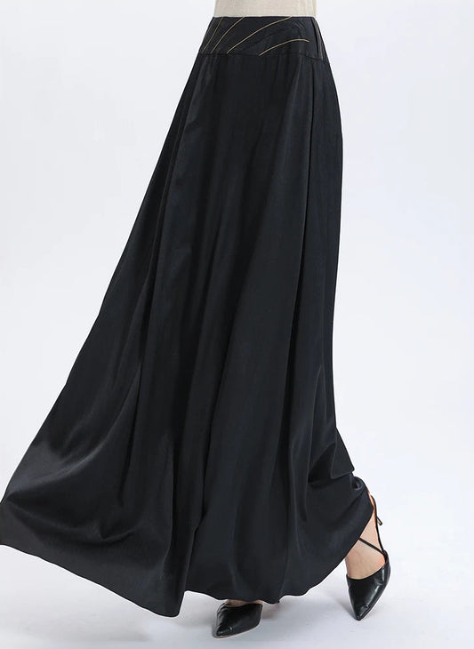 A cinematic shot of the heavy black silk skirt in motion, capturing the oily density and slow whirlpool effect of the 40 momme fabric — From Borcelleclothes.