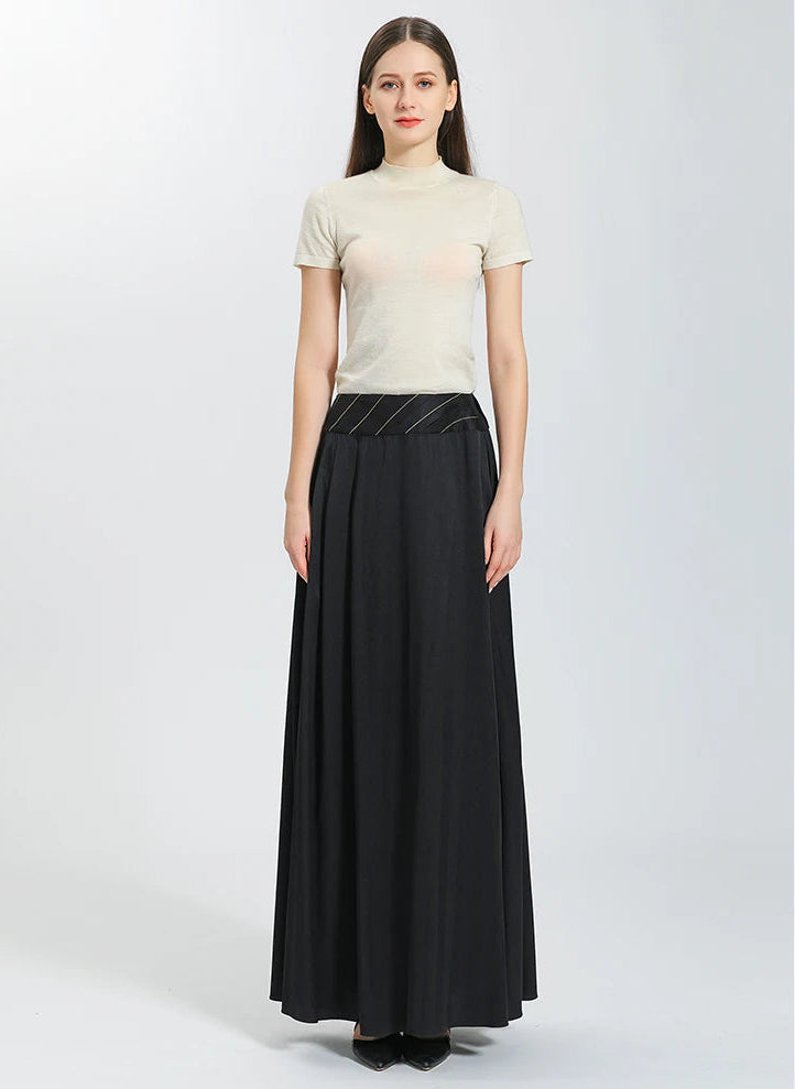 Front view of a woman wearing the high-end floor-length Mulberry silk skirt in Deep Waters black, showcasing its elegant straight silhouette and structured waist — From Borcelleclothes.