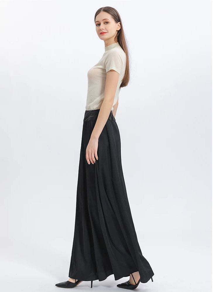 Side profile of a model walking in the heavy 40 momme silk skirt, demonstrating the fluid, majestic movement of the luxury fabric — From Borcelleclothes.