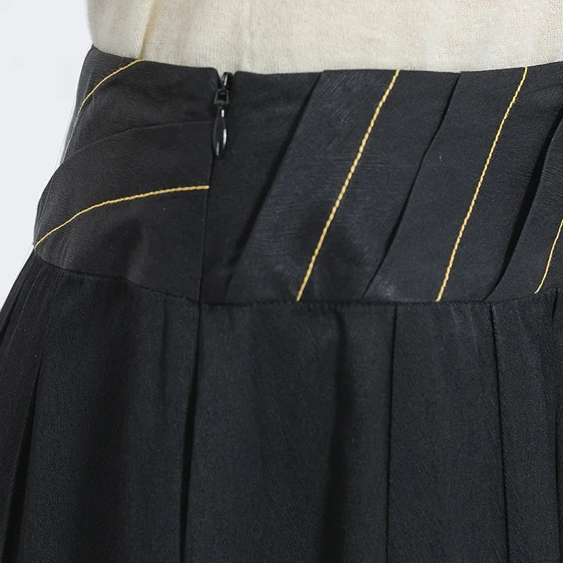 High-resolution close-up of the seamless, high-end zipper closure on the structured waist section of the black silk skirt — From Borcelleclothes.