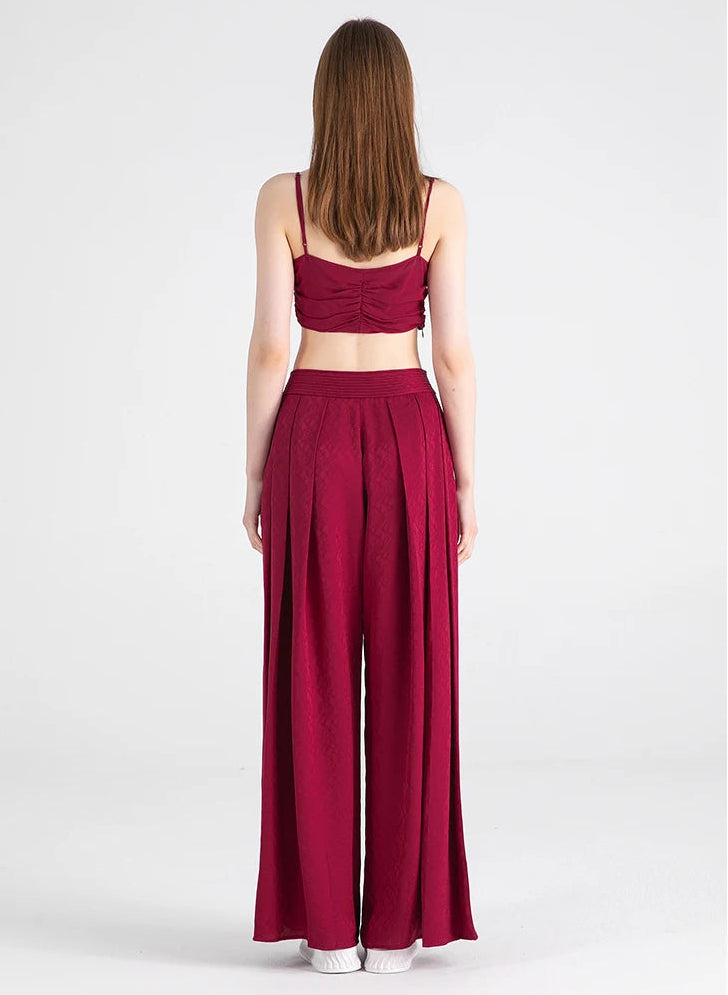 Full-height back view of women’s pleated yoke silk trousers in Queen of Night — From Borcelleclothes.