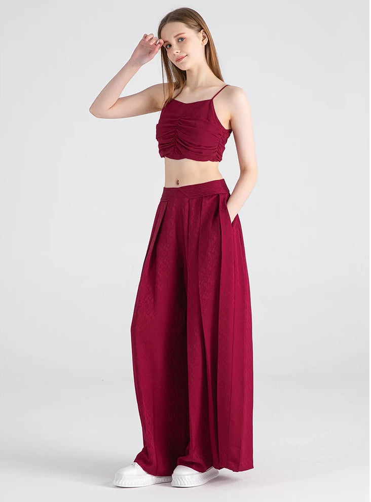Full-height view of a model in Queen of Night Mulberry silk wide-leg trousers — From Borcelleclothes.
