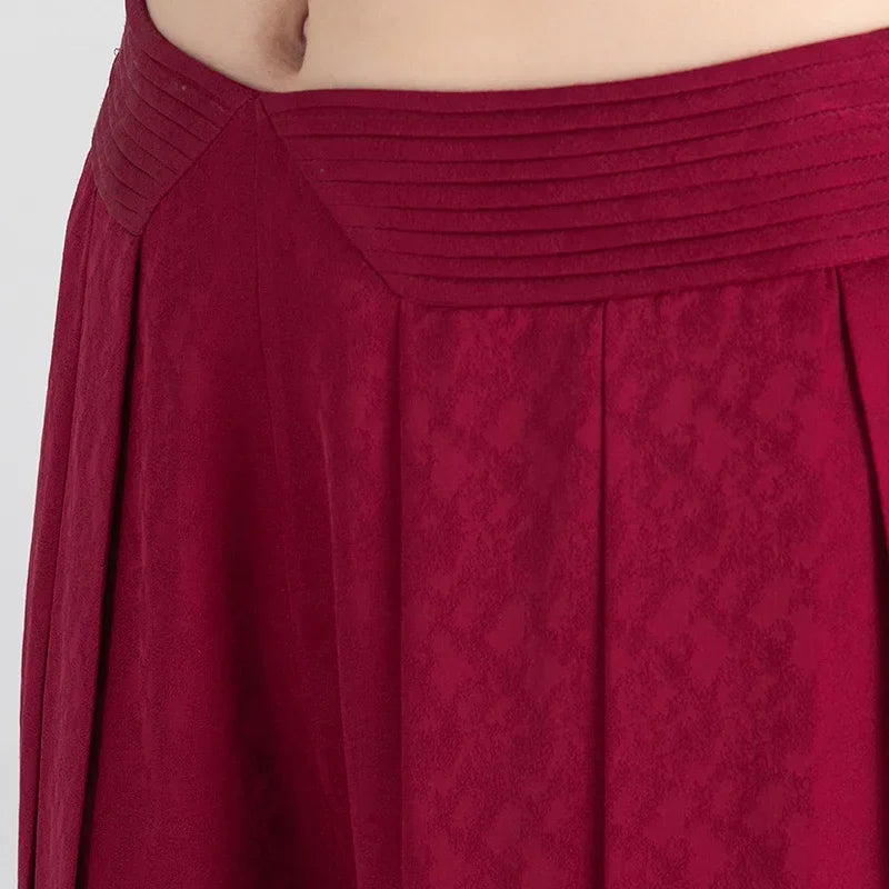 Detailed shot of the horizontally pleated waist yoke on Mulberry silk jacquard trousers — From Borcelleclothes.