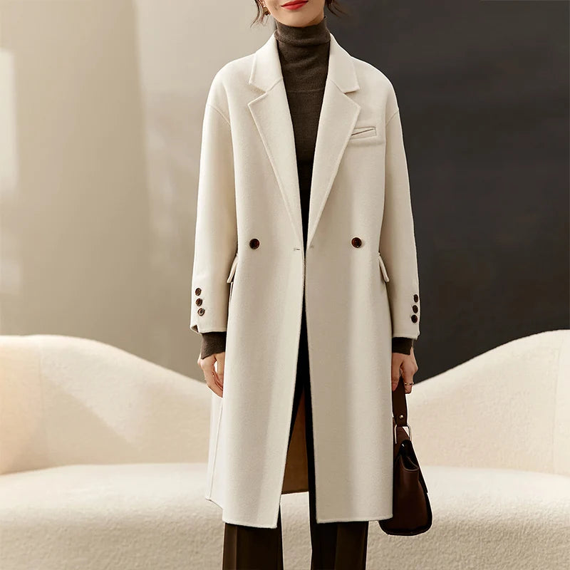 Women's double-sided wool coat in Piano color, featuring notch lapels, dropped shoulders, and a seamless, fluid silhouette. — From Borcelleclothes.