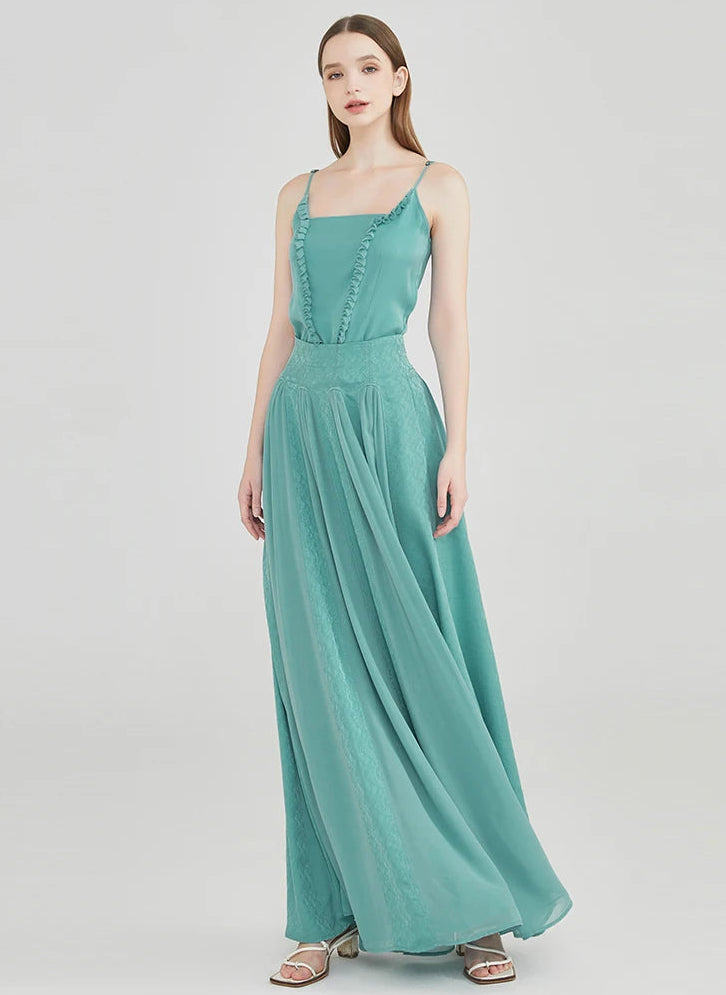 The aqua-mint silk maxi skirt caught in dynamic motion, showing the fluid, waterfall-like movement of the semi-sheer georgette cascades — From Borcelleclothes.