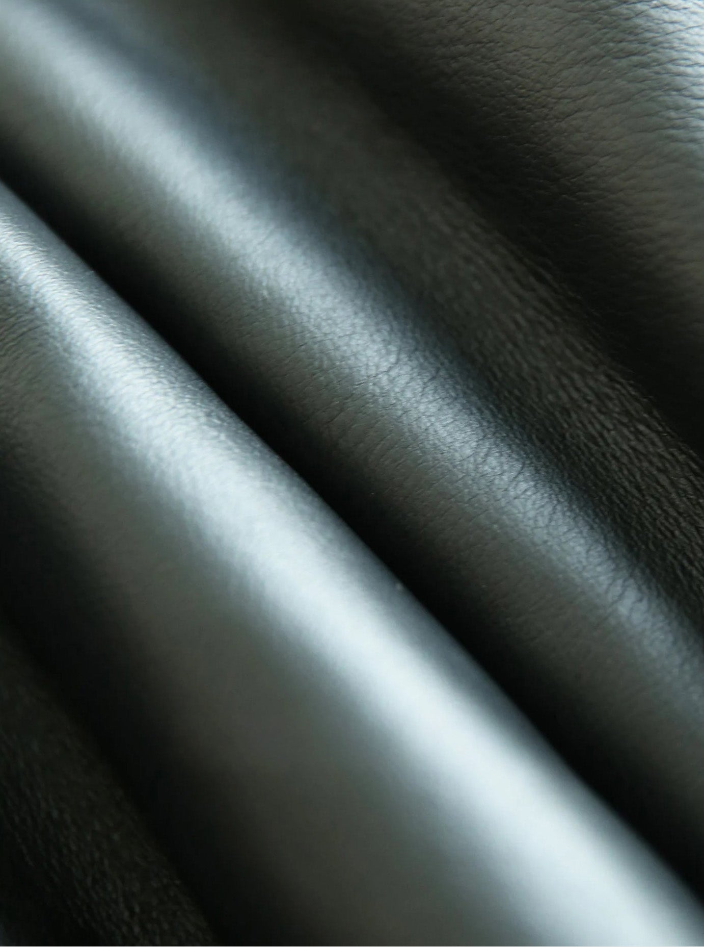 Folded leather surface of the Autographe jacket showing subtle structure and movement — From Borcelleclothes.