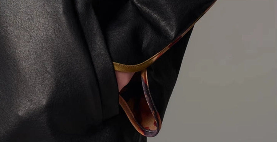 Close-up of the overlapping kimono sleeve finished with rounded petal cuffs and bound edging — From Borcelleclothes.