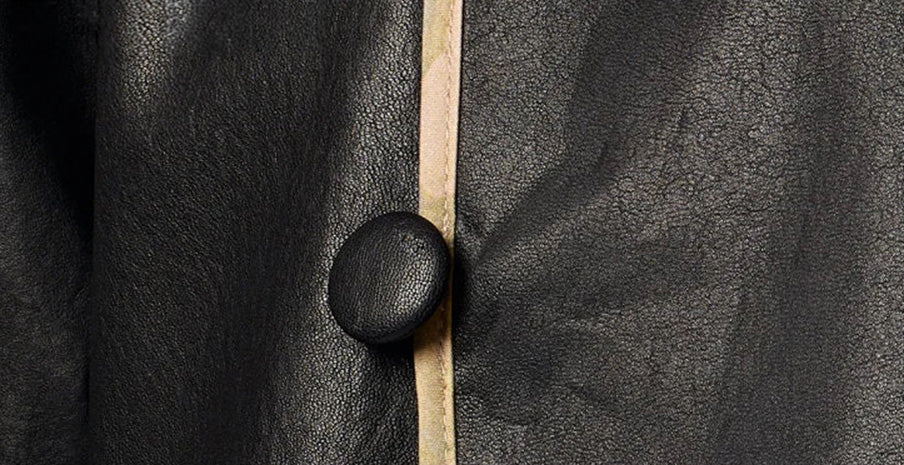 Detail of the handcrafted leather-covered button and cord loop closure on fine sheepskin Nappa — From Borcelleclothes.