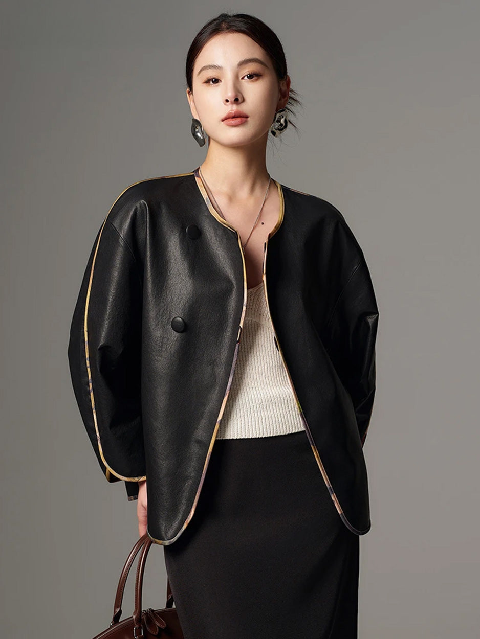 Model styled with an accessory in the black Nappa leather reversible kimono jacket — From Borcelleclothes.