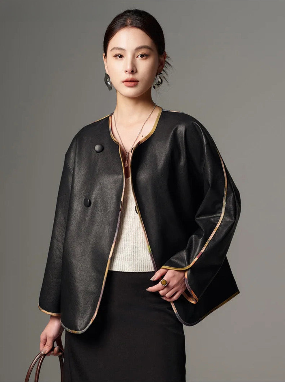 Unfastened black Nappa leather kimono jacket revealing glimpses of the printed silk-satin reverse — From Borcelleclothes.