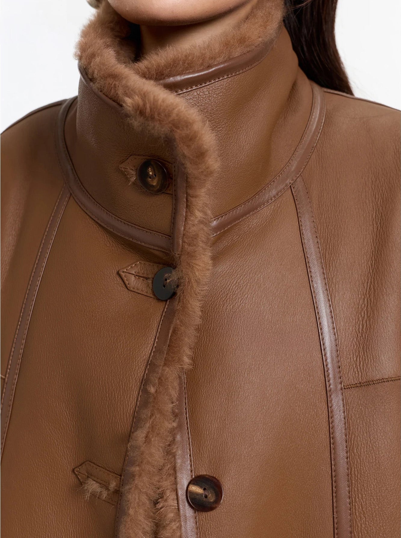 Close-up of the Cedar Resin shearling coat with fastened collar, leather side out — From Borcelleclothes.