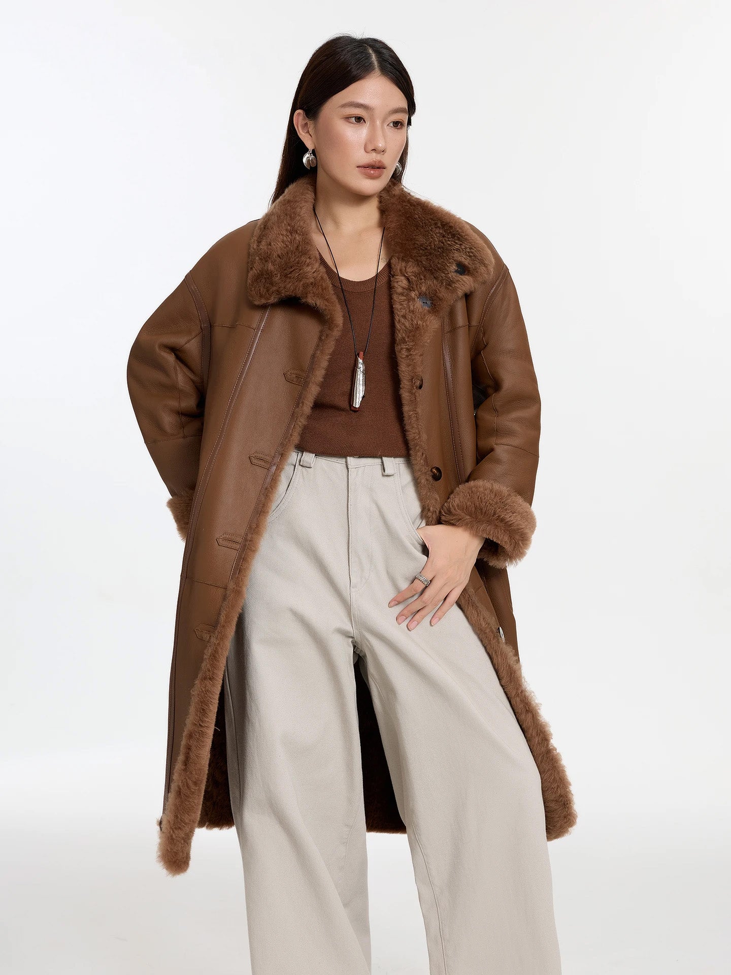 Model wearing Cedar Resin shearling coat unfastened, hand behind back, leather side out — From Borcelleclothes.