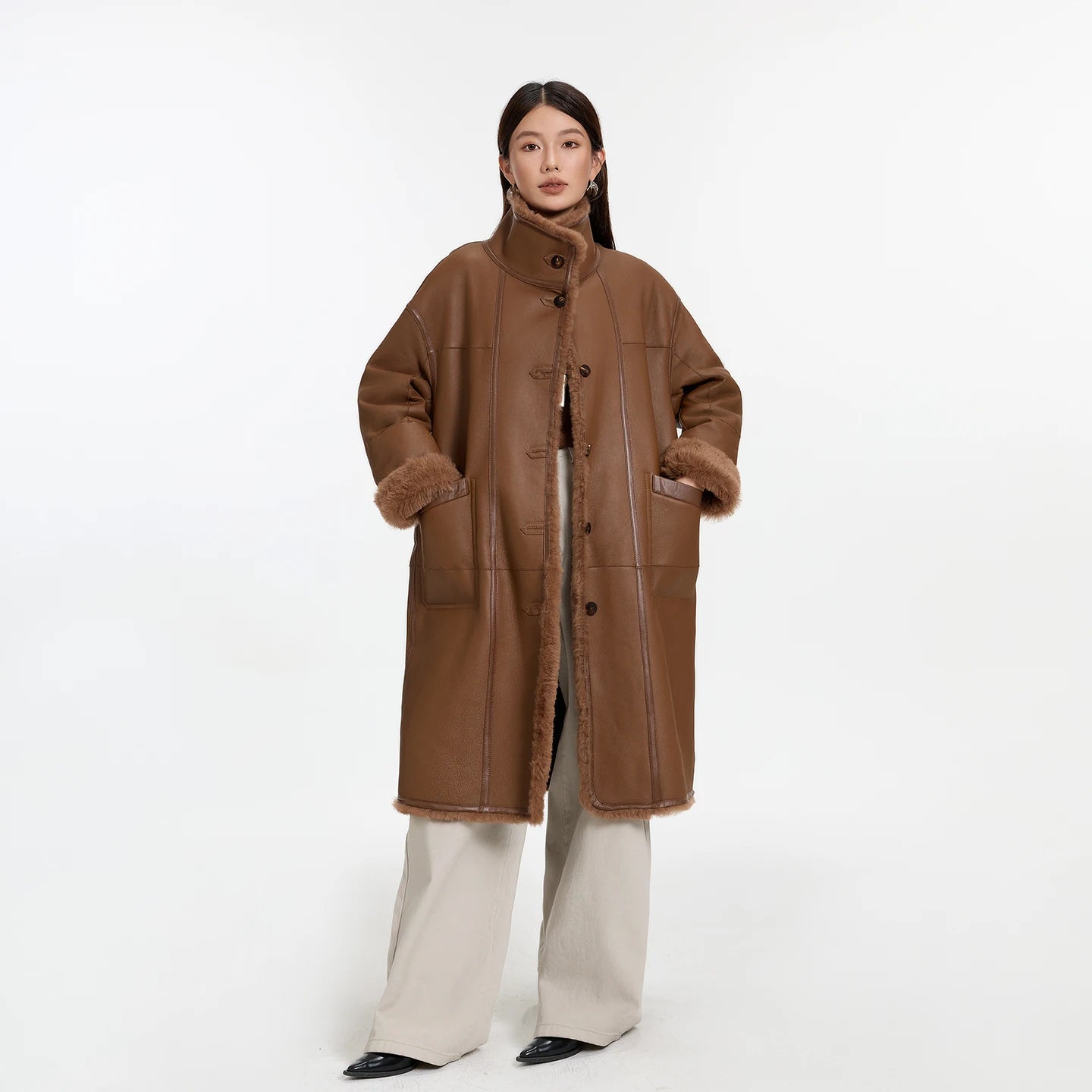 Women’s reversible shearling coat in Cedar Resin color, featuring glossy leather trims and mid-calf silhouette — From Borcelleclothes.
