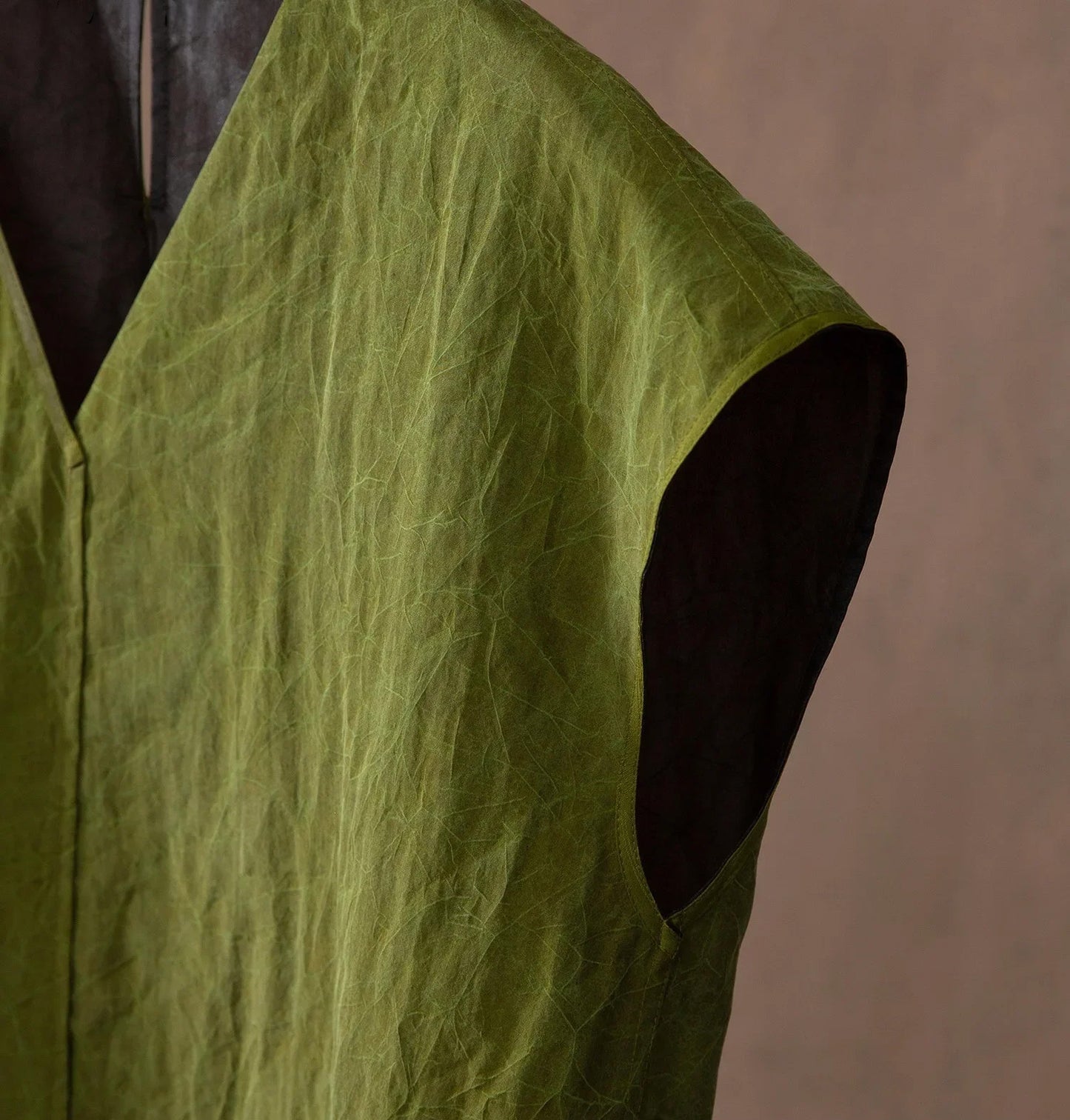 Detail of the sleeve armhole on an olive silk top — From Borcelleclothes.