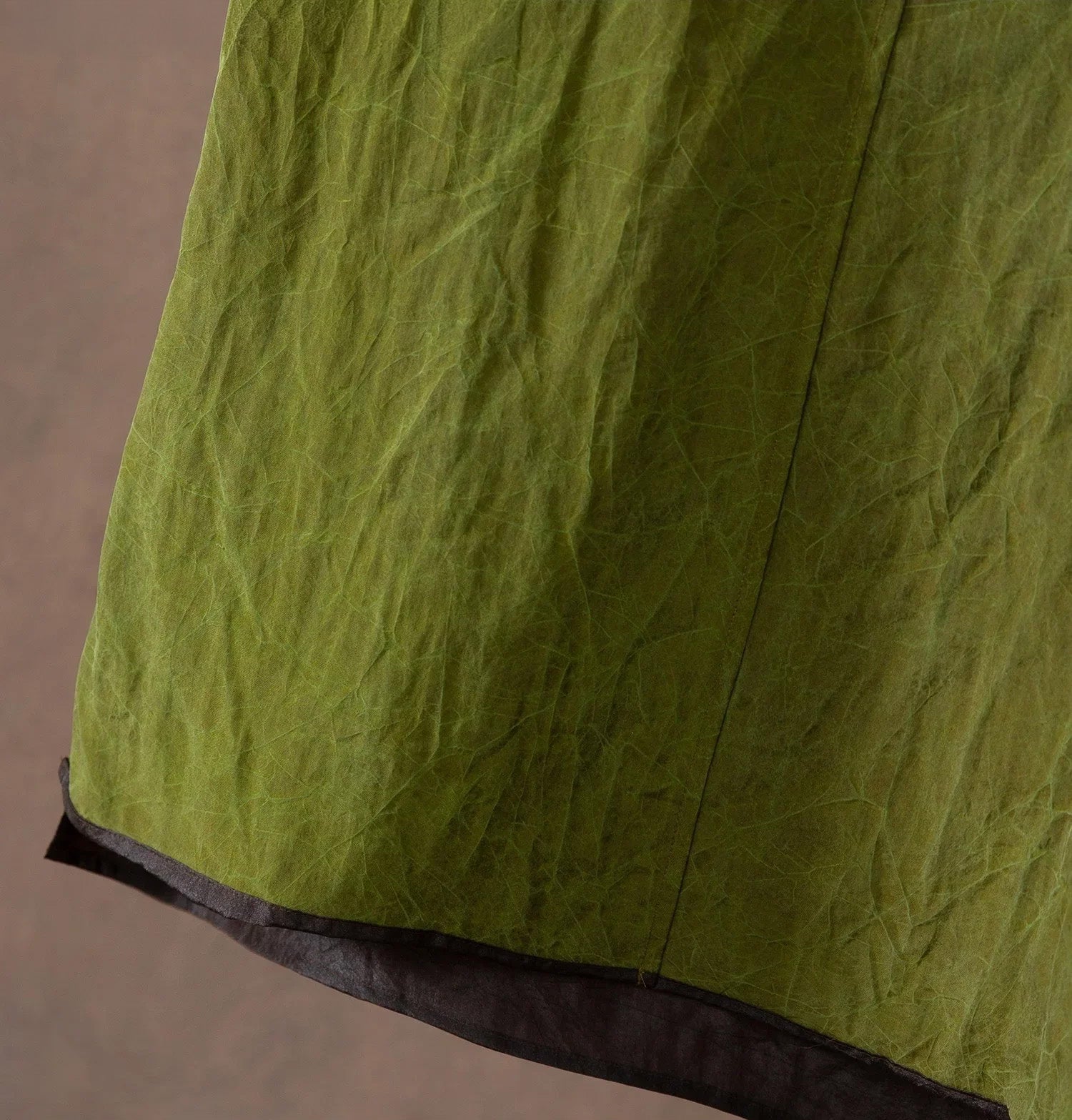 Detail of the stepped bottom hem on an olive silk top — From Borcelleclothes.