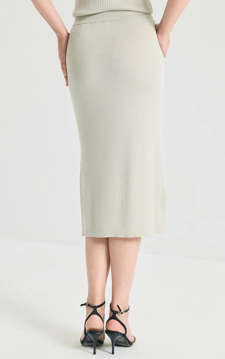 Back view of a model wearing the straight silhouette midi wool-silk skirt in Compliant Sage green. From Borcelleclothes.