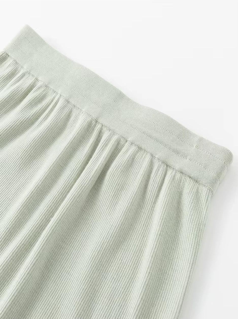 Close-up view of the clean triple-casing elastic waistband on the rib knit wool-silk skirt in Compliant Sage green. From Borcelleclothes.